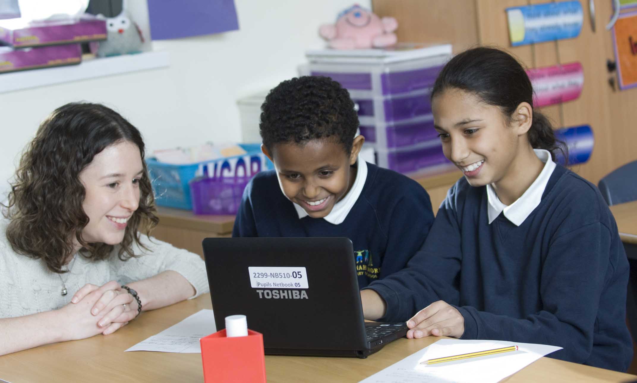Children learning with a laptop